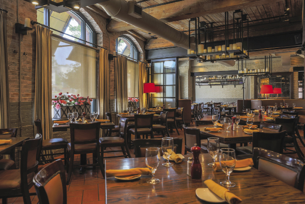 Inside a restaurant with wooden tables and tall windows