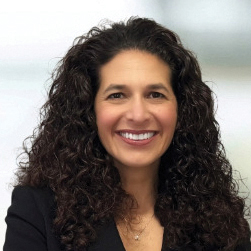 A woman with long, brown curly hair 
