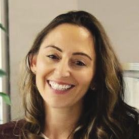 A woman with long brown hair with blonde highlights